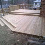 multi-level wood deck with steps following the slope of the ground