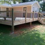 Wood deck with black round aluminum balusters