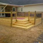 wood deck with custom "in-set" steps and solar light in the step risers