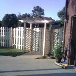6' Tall Shadow Box Fence with Arbor over the Entrance Gate.